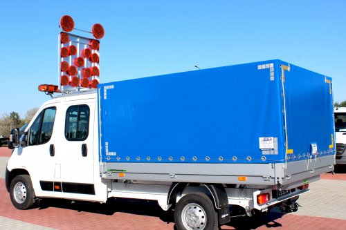 AG Zabudowy - Realizacje - Peugeot Boxer - skrzynia z plandeką ze znakiem ostrzegawczym